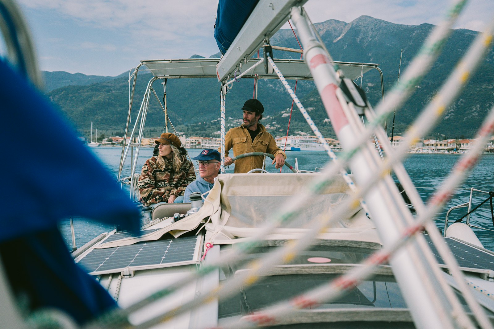Guests sailing a small boat with mountains behind
